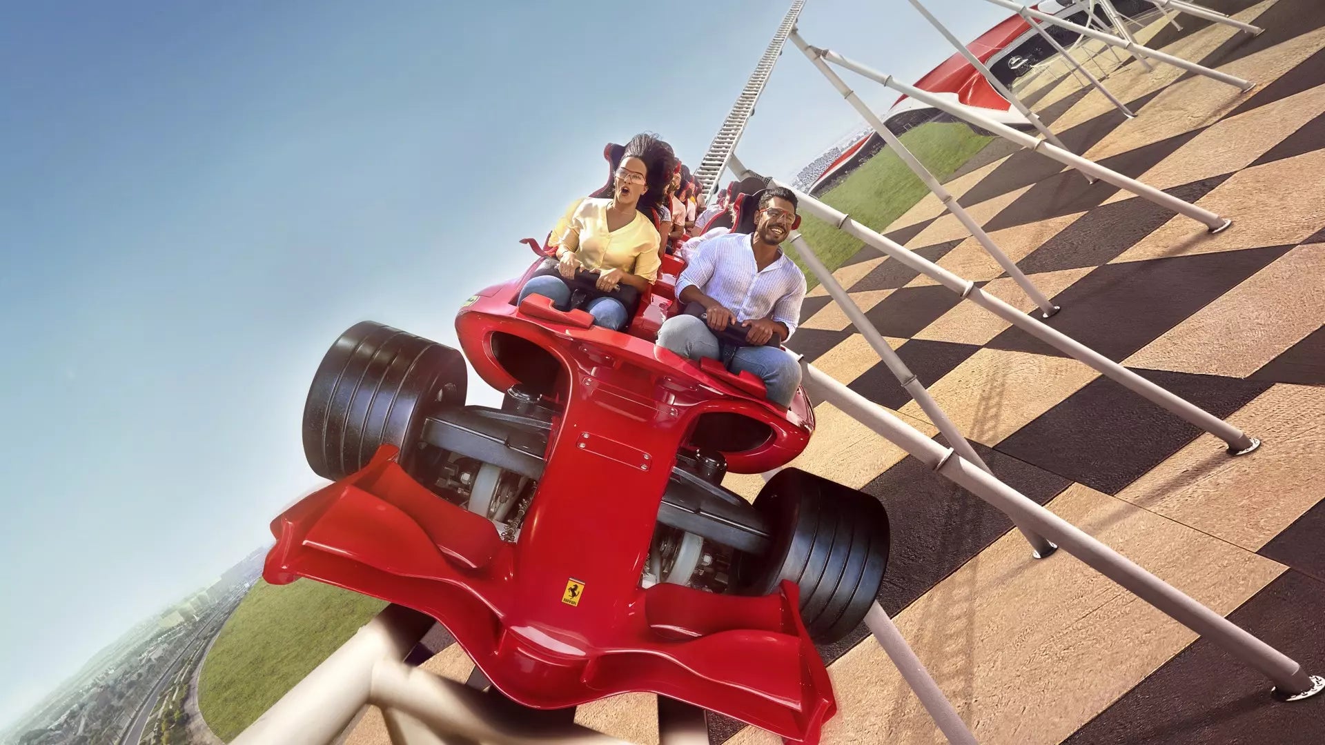 People on a roller coaster car with a checkered pattern on the ground